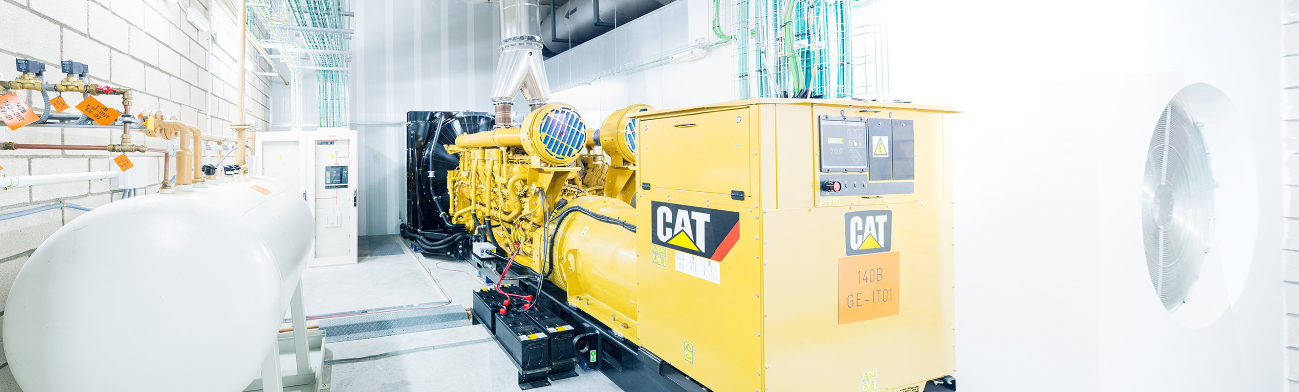 Photo of a CAT generator inside a data center room with colorful  lighting in the room shot by Timo Arnal